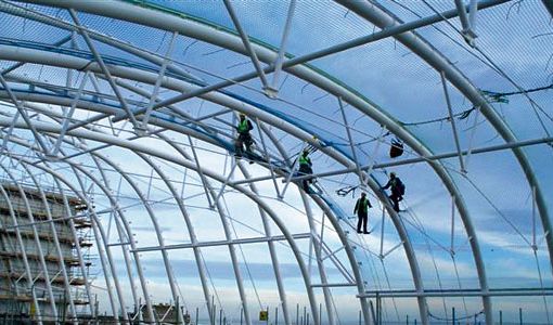 workers on a building site with safety nets