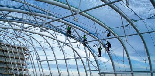 workers on a building site with safety nets